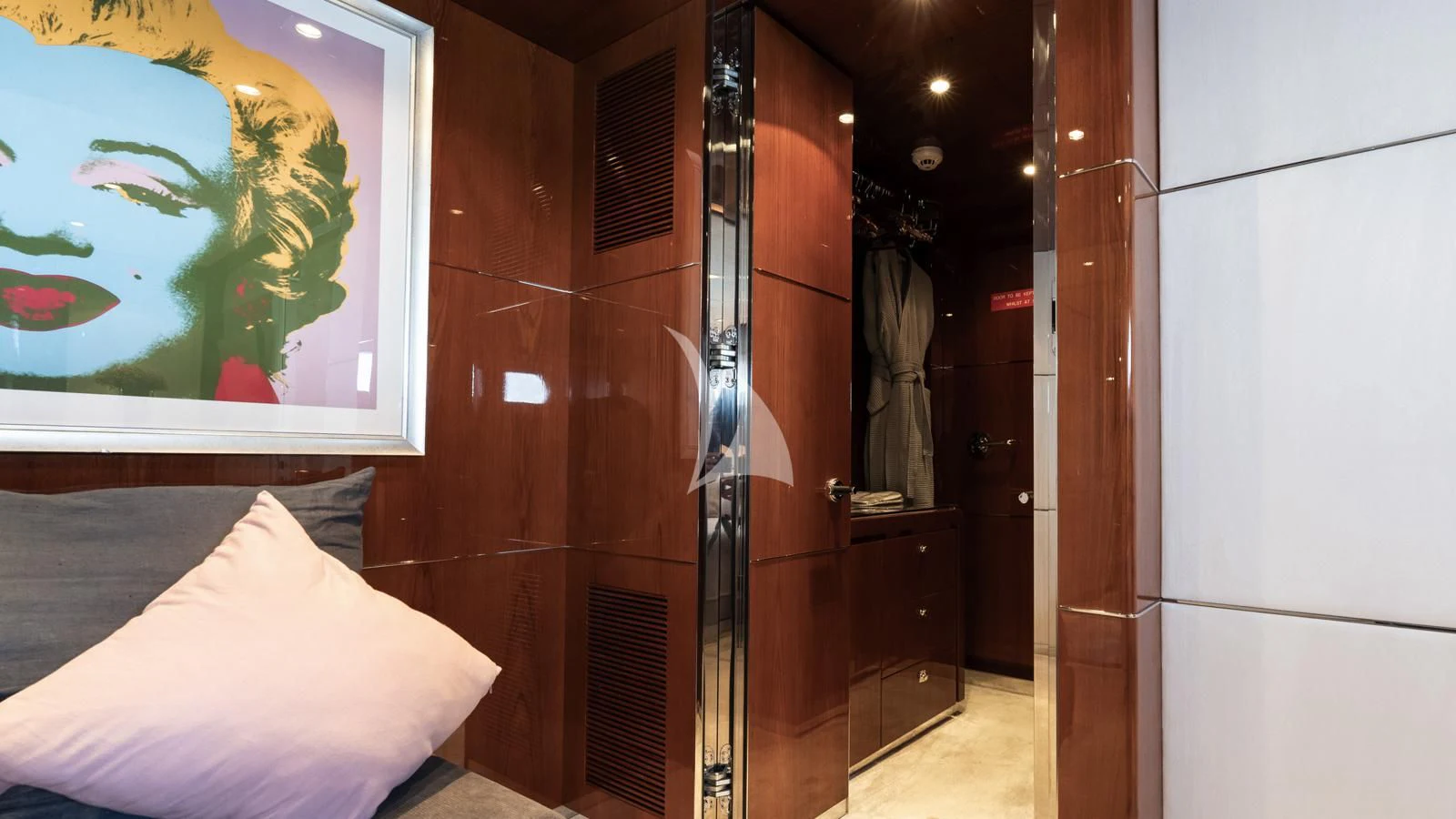 a room with a bed and a painting on the wall aboard BLISS Yacht for Sale