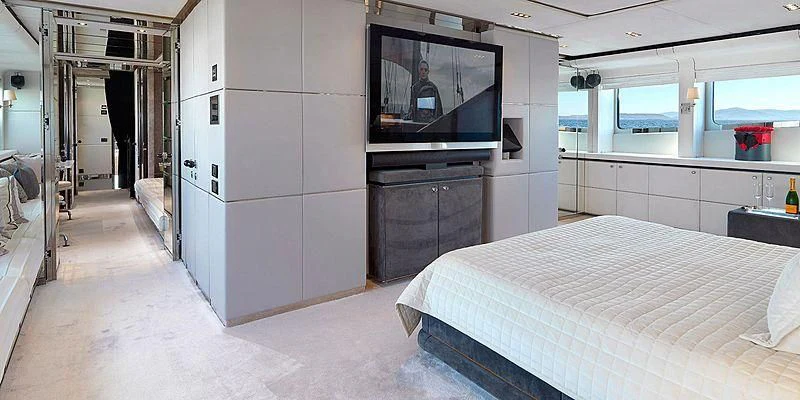 a room with a bed and tv aboard BLISS Yacht for Sale
