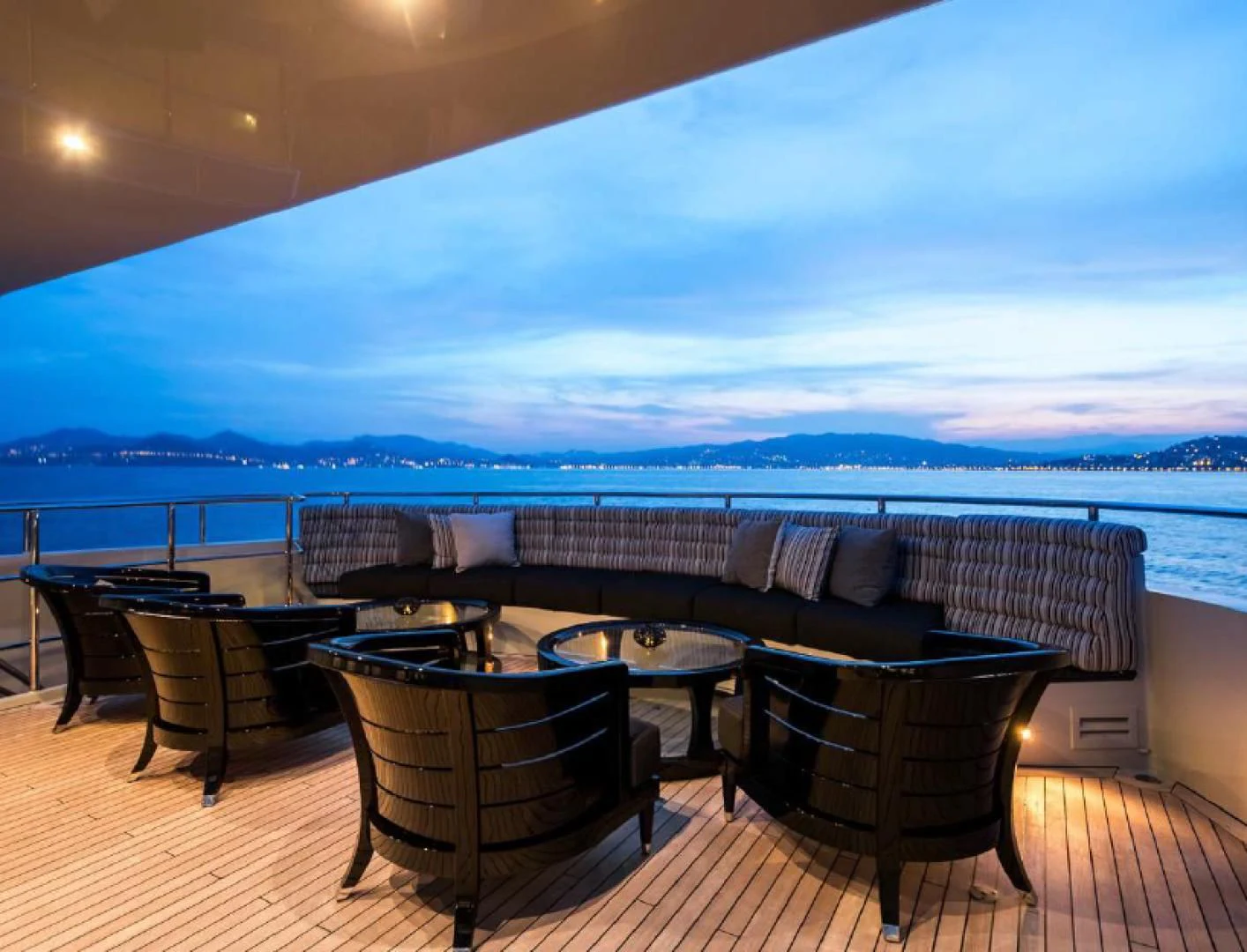 a patio with a table and chairs aboard BLISS Yacht for Sale