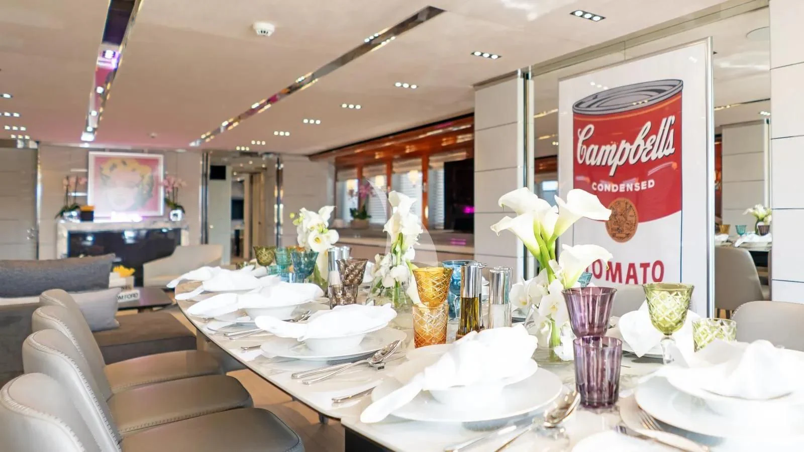 a restaurant with tables and chairs aboard BLISS Yacht for Sale