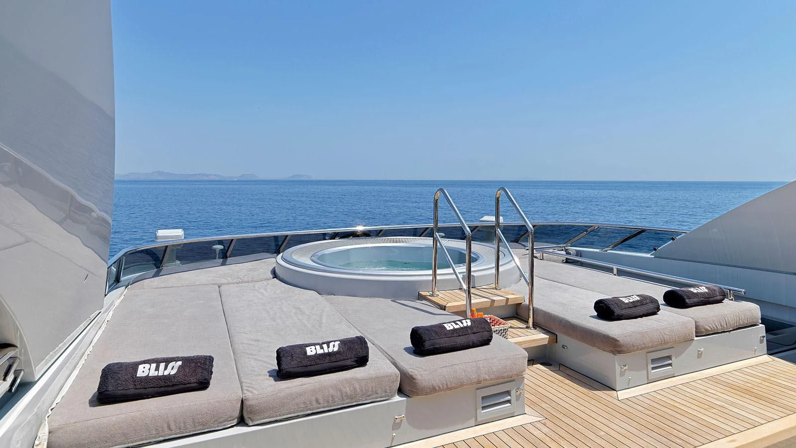 a deck with a pool and a deck overlooking the ocean aboard BLISS Yacht for Sale