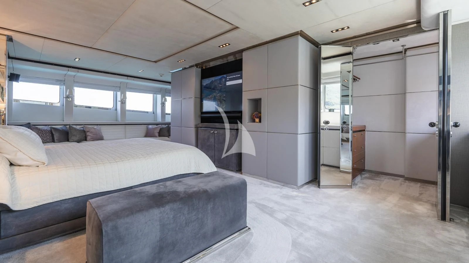 a bedroom with a bed and a desk aboard BLISS Yacht for Sale