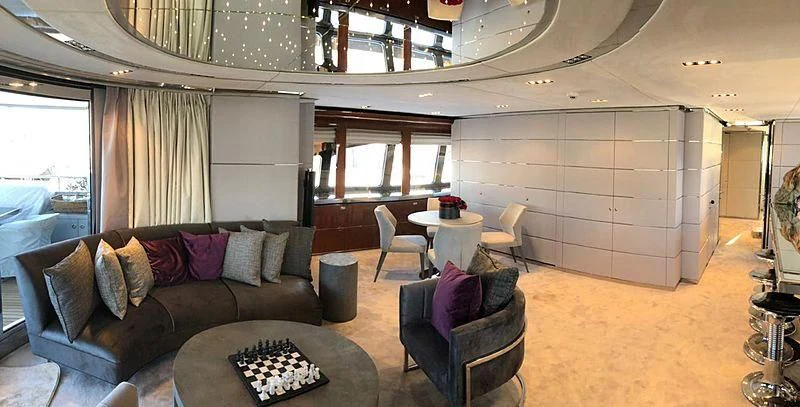 a living room with a couch and a table aboard BLISS Yacht for Sale