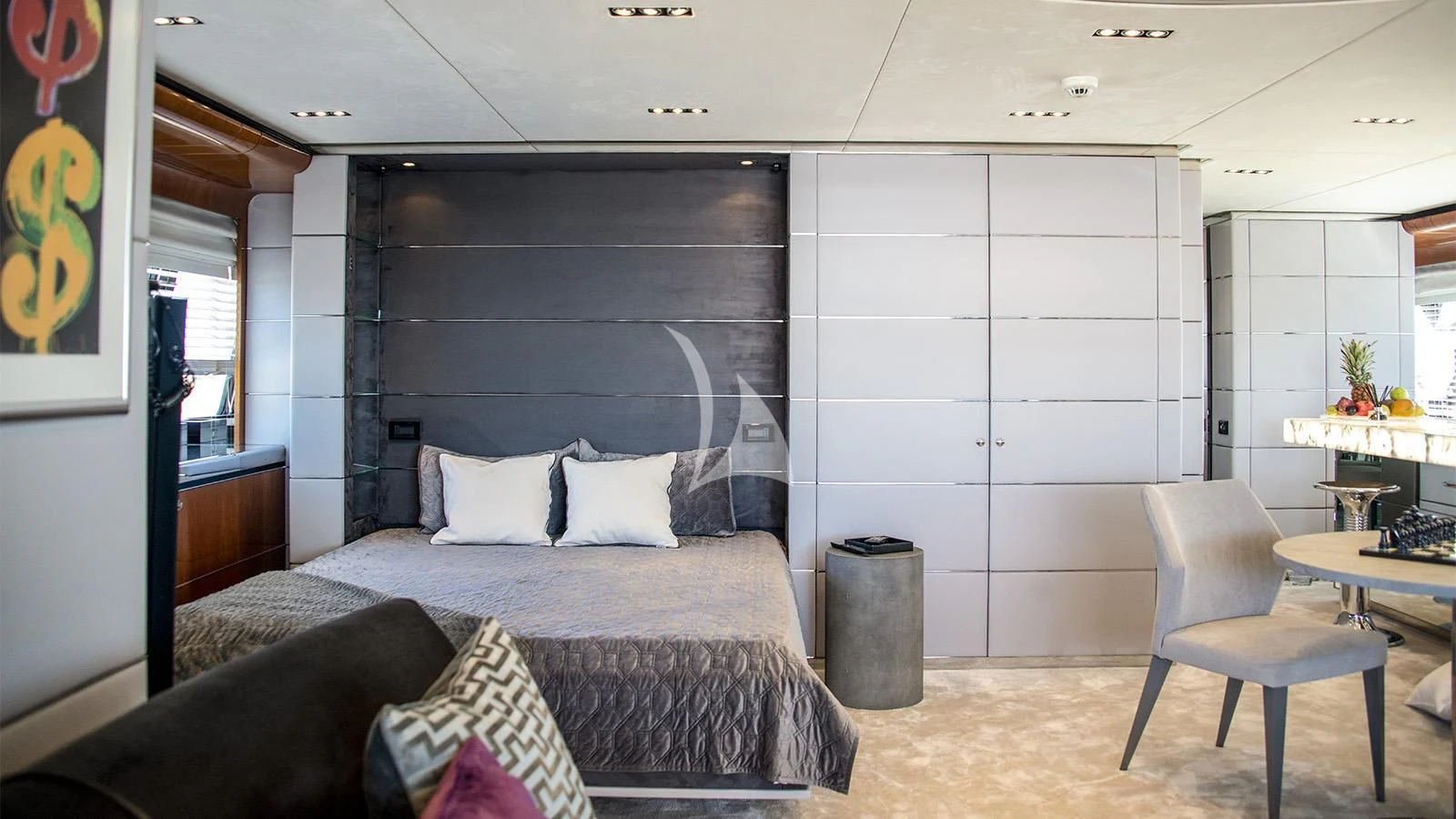 a bedroom with a bed and a chair aboard BLISS Yacht for Sale