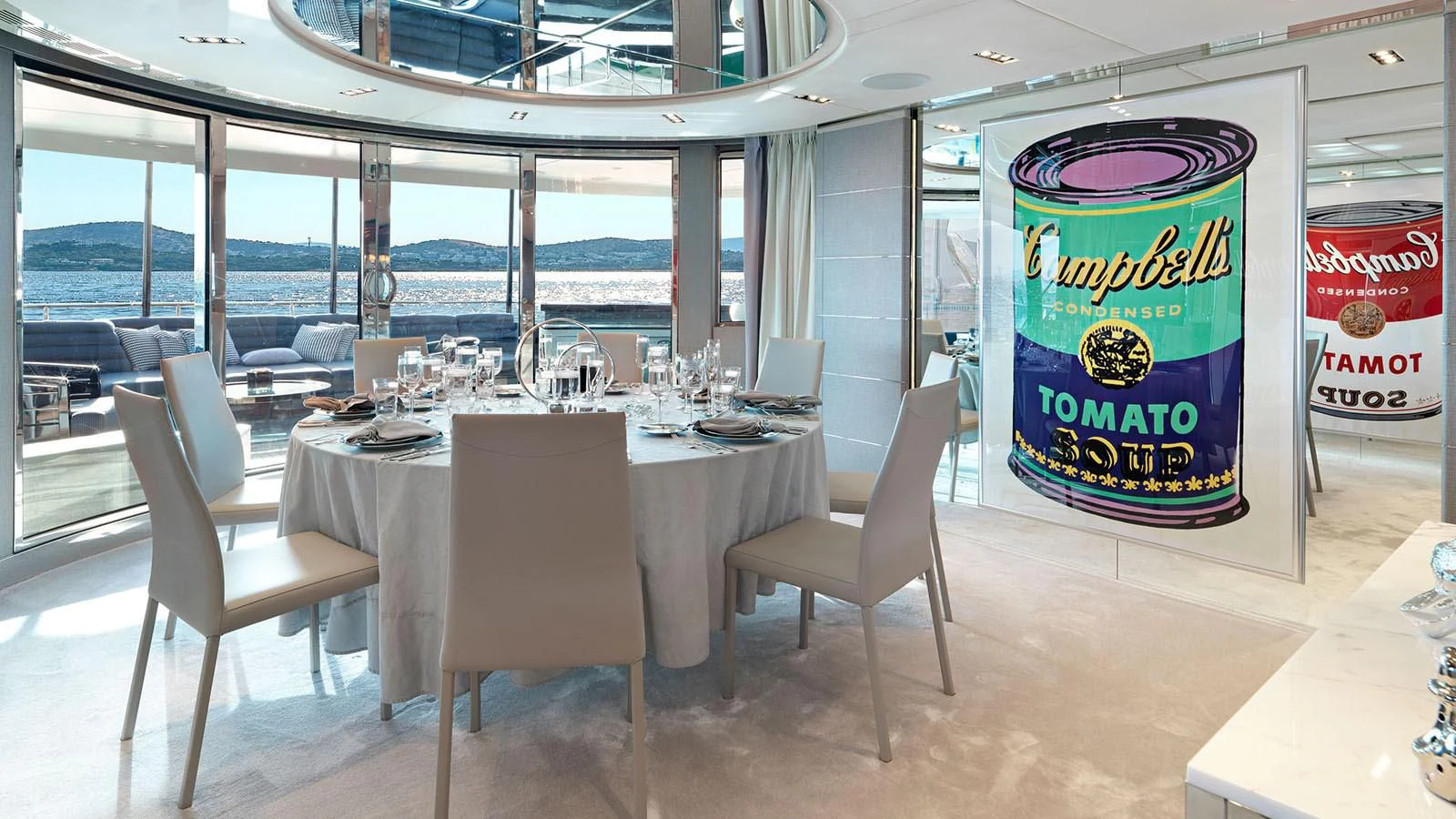 a table with chairs and a sign aboard BLISS Yacht for Sale