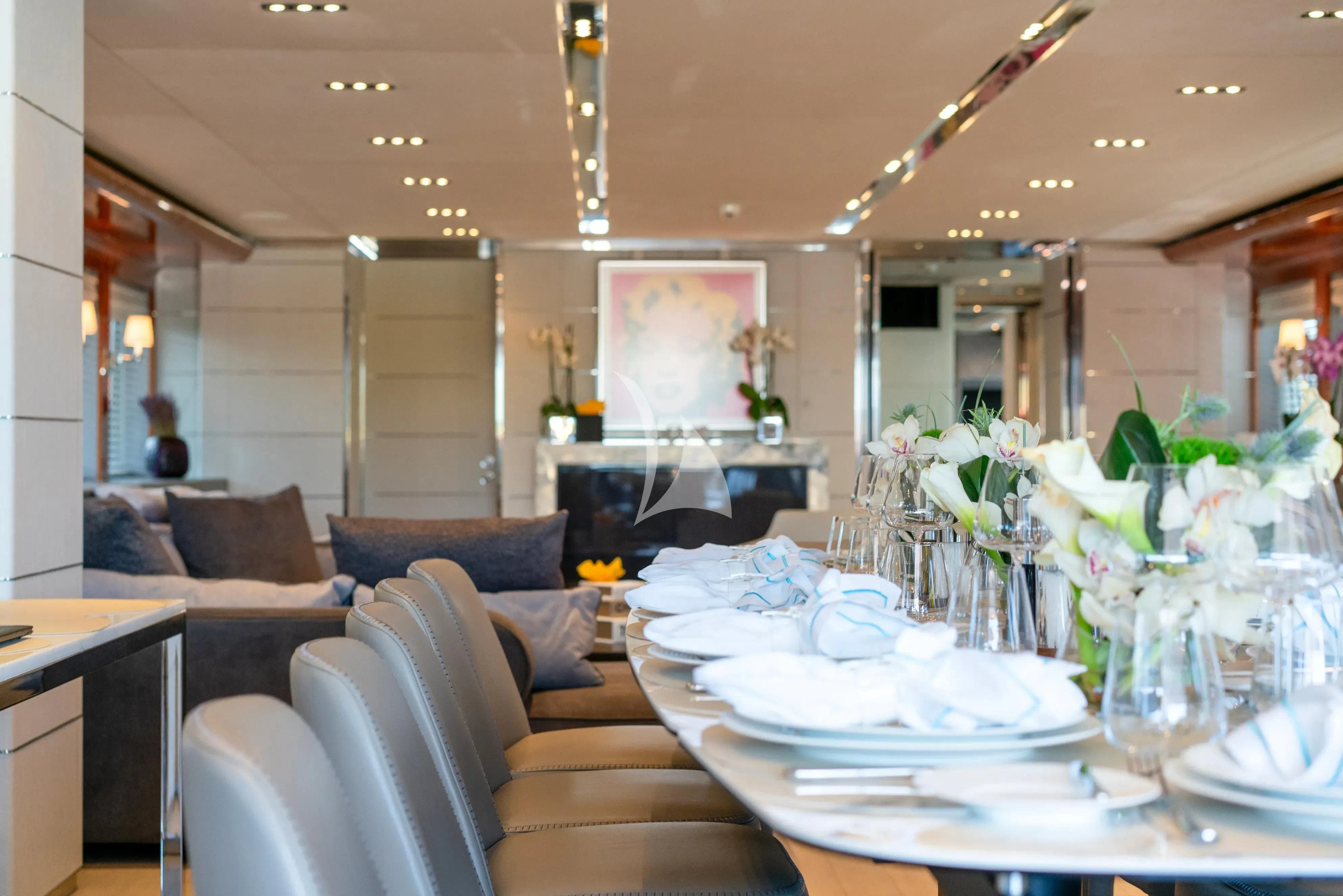 a room with a table and couches aboard BLISS Yacht for Sale