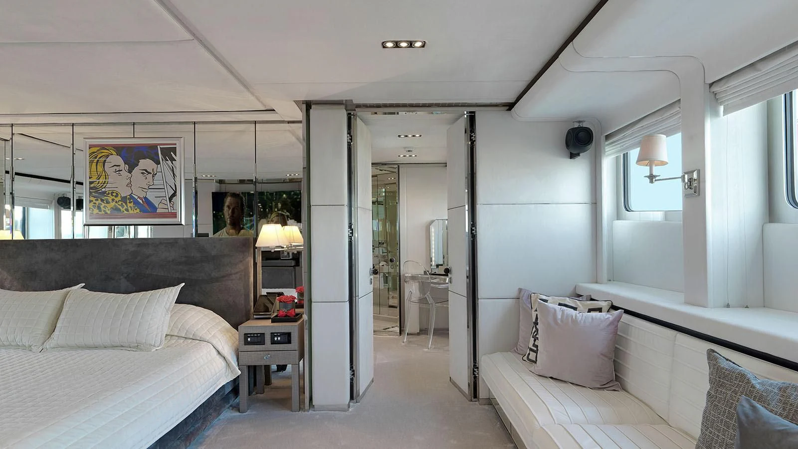 a bedroom with a bed and a mirror aboard BLISS Yacht for Sale