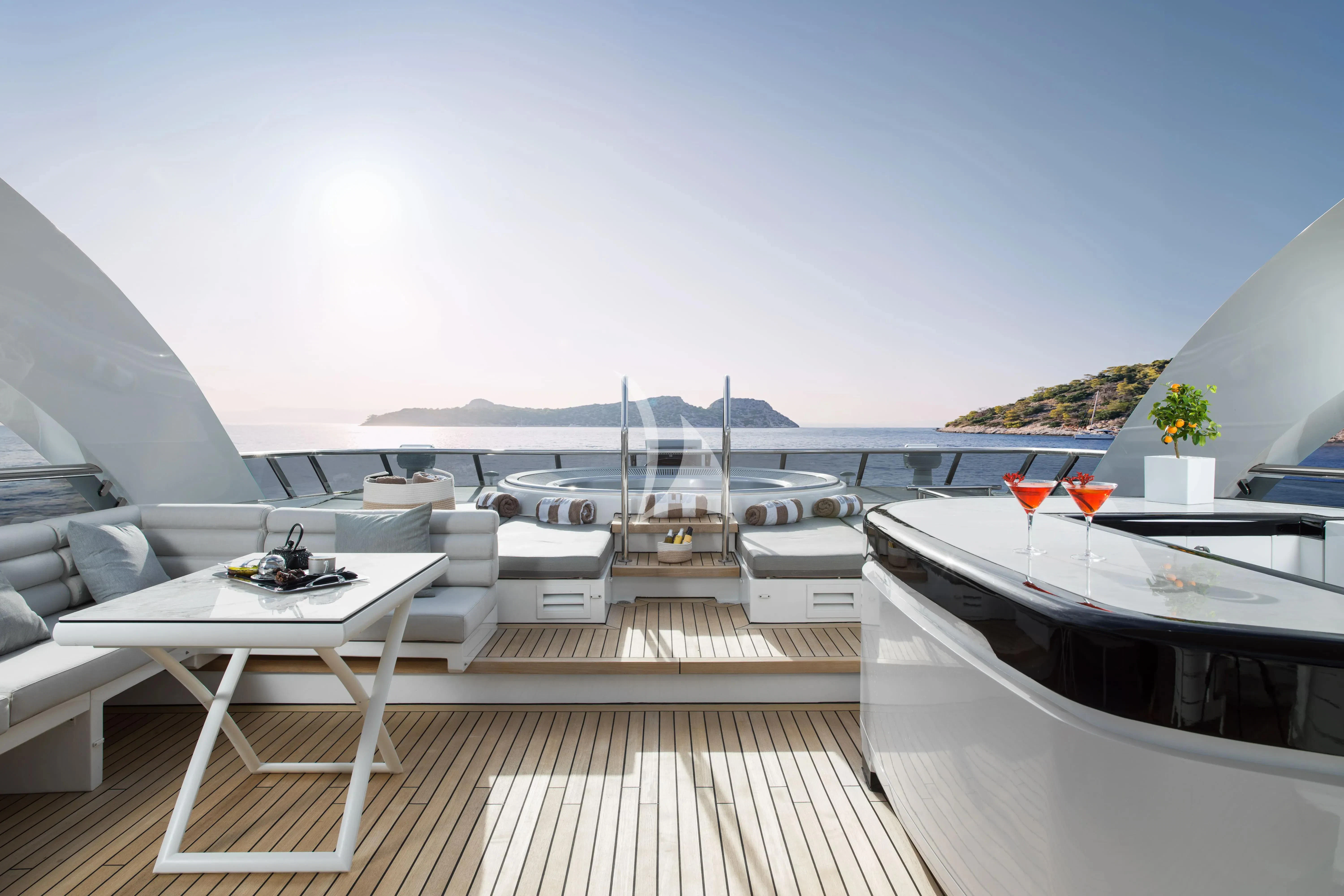 a deck with a view of the ocean and a boat aboard BLISS Yacht for Sale