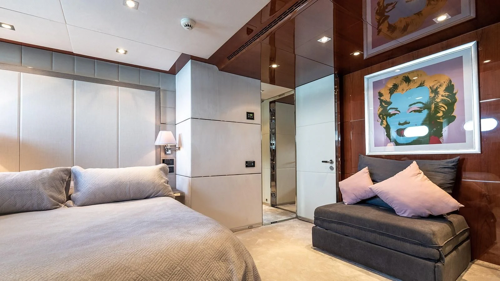 a room with a bed and a painting on the wall aboard BLISS Yacht for Sale