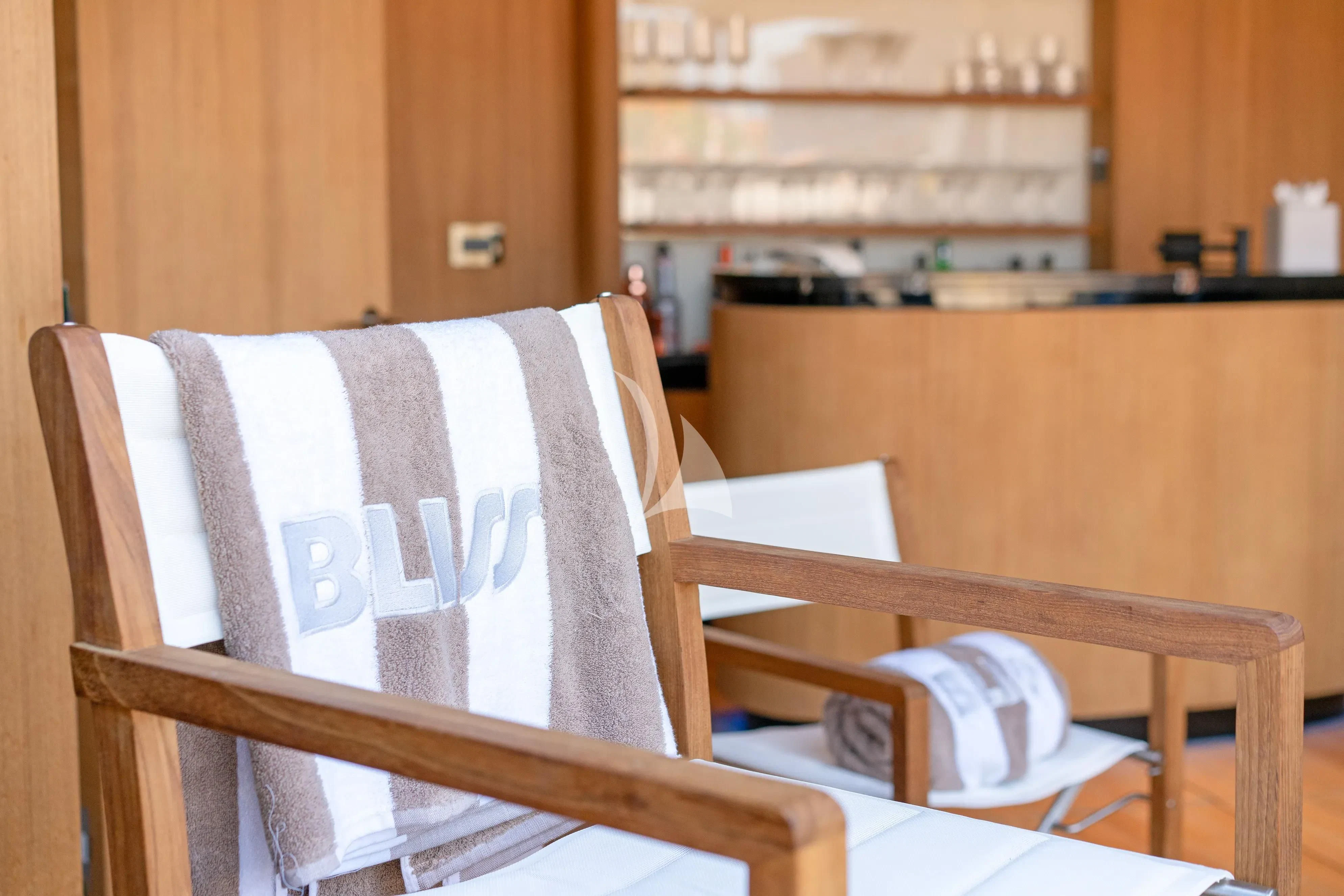 a wooden chair with a white sheet aboard BLISS Yacht for Sale