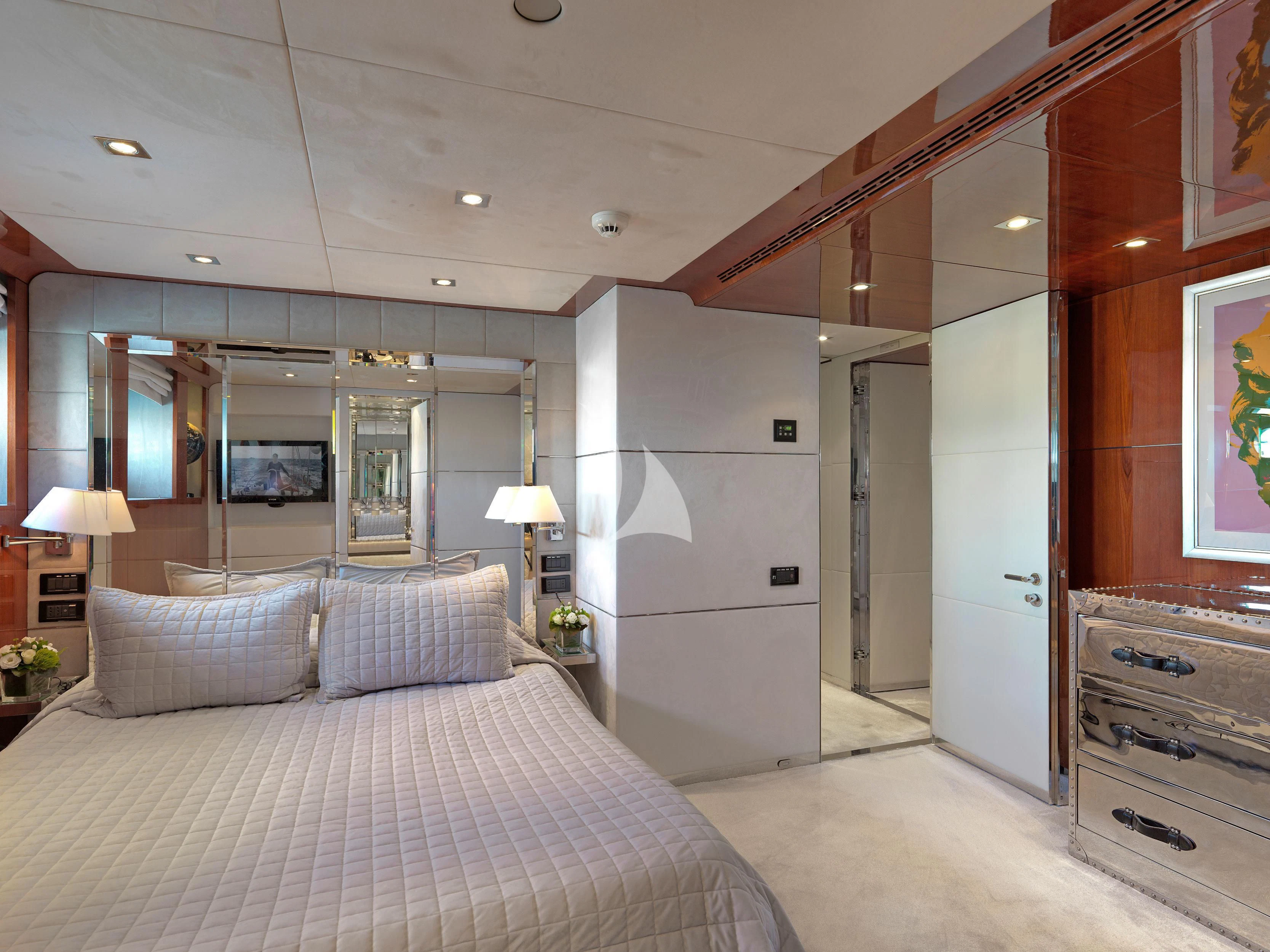 a bedroom with a bed and a mirror aboard BLISS Yacht for Sale