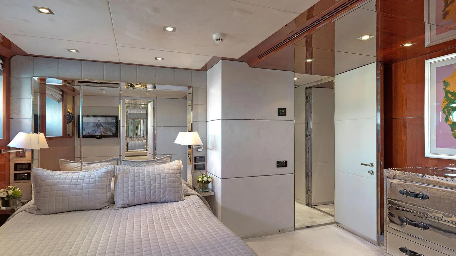 a bedroom with a bed and a desk aboard BLISS Yacht for Sale