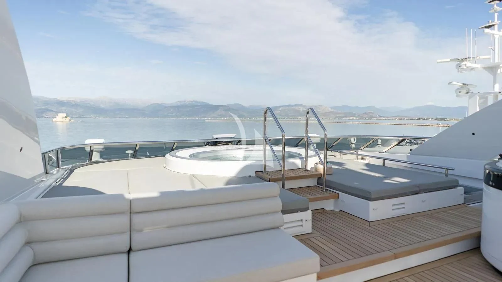 a deck with a deck and a view of the mountains aboard BLISS Yacht for Sale