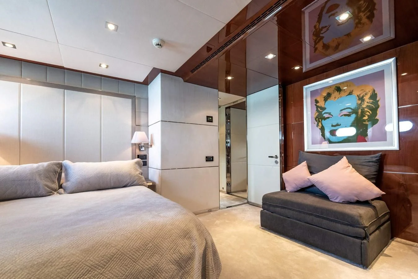 a room with a bed and a painting on the wall aboard BLISS Yacht for Sale
