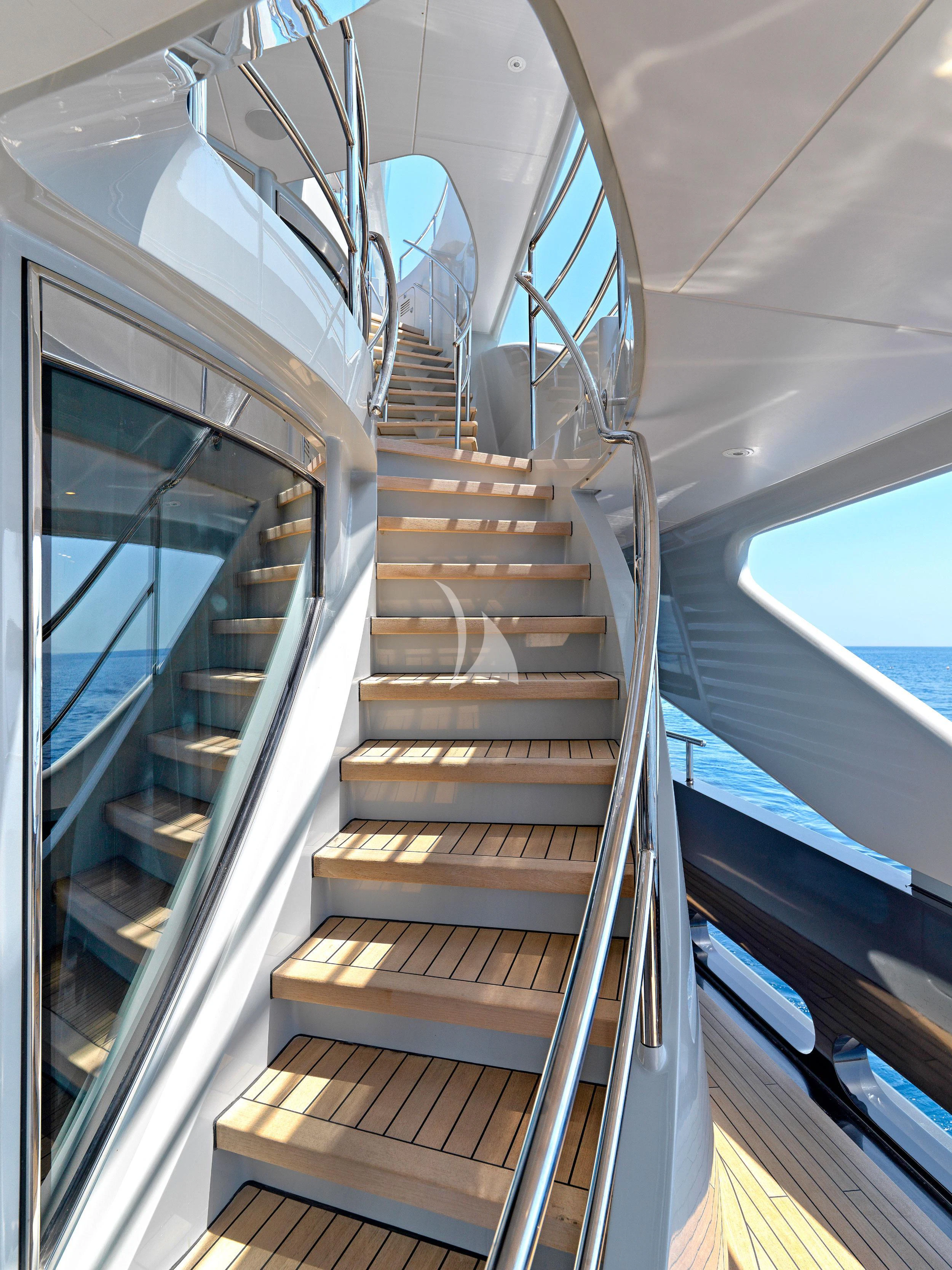 a staircase with glass walls aboard BLISS Yacht for Sale