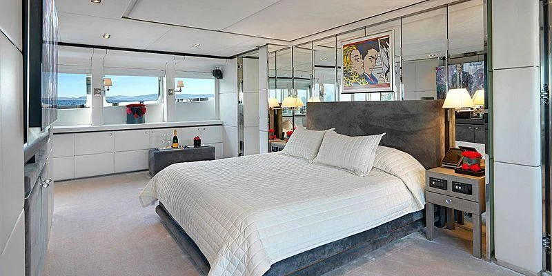 a bedroom with a bed and a desk aboard BLISS Yacht for Sale