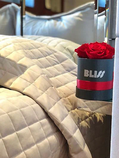 a bottle of soda on a bed aboard BLISS Yacht for Sale