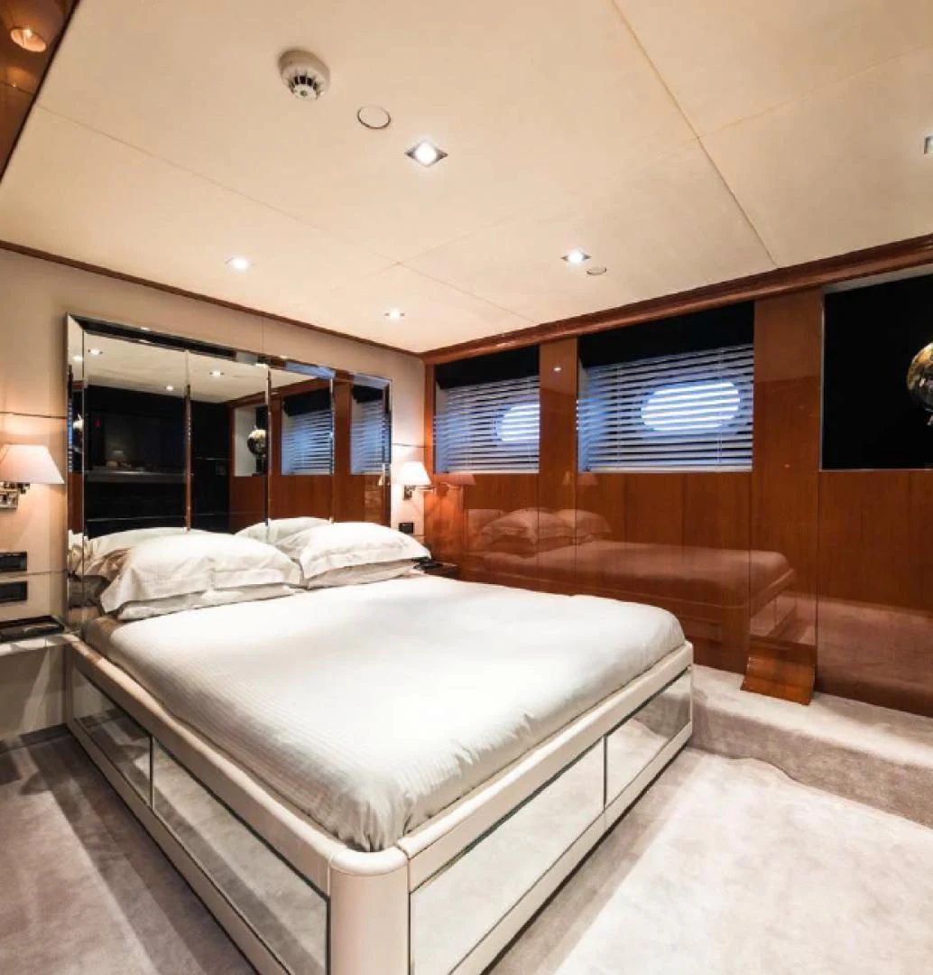 a room with a bed and a mirror aboard BLISS Yacht for Sale