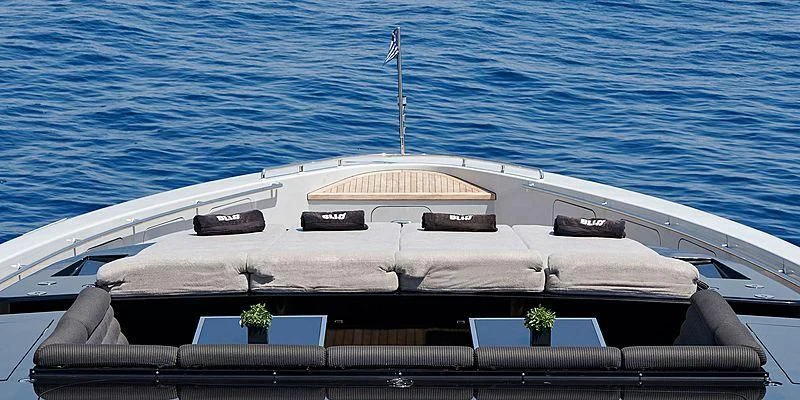 a white boat with a flag on it aboard BLISS Yacht for Sale