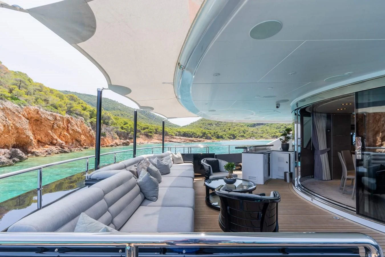 a deck with a table and chairs aboard BLISS Yacht for Sale
