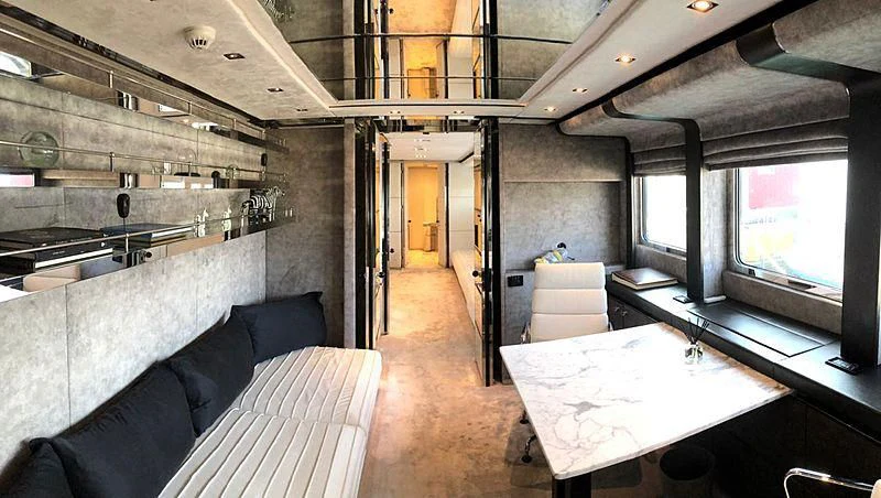 a room with a table and couches aboard BLISS Yacht for Sale