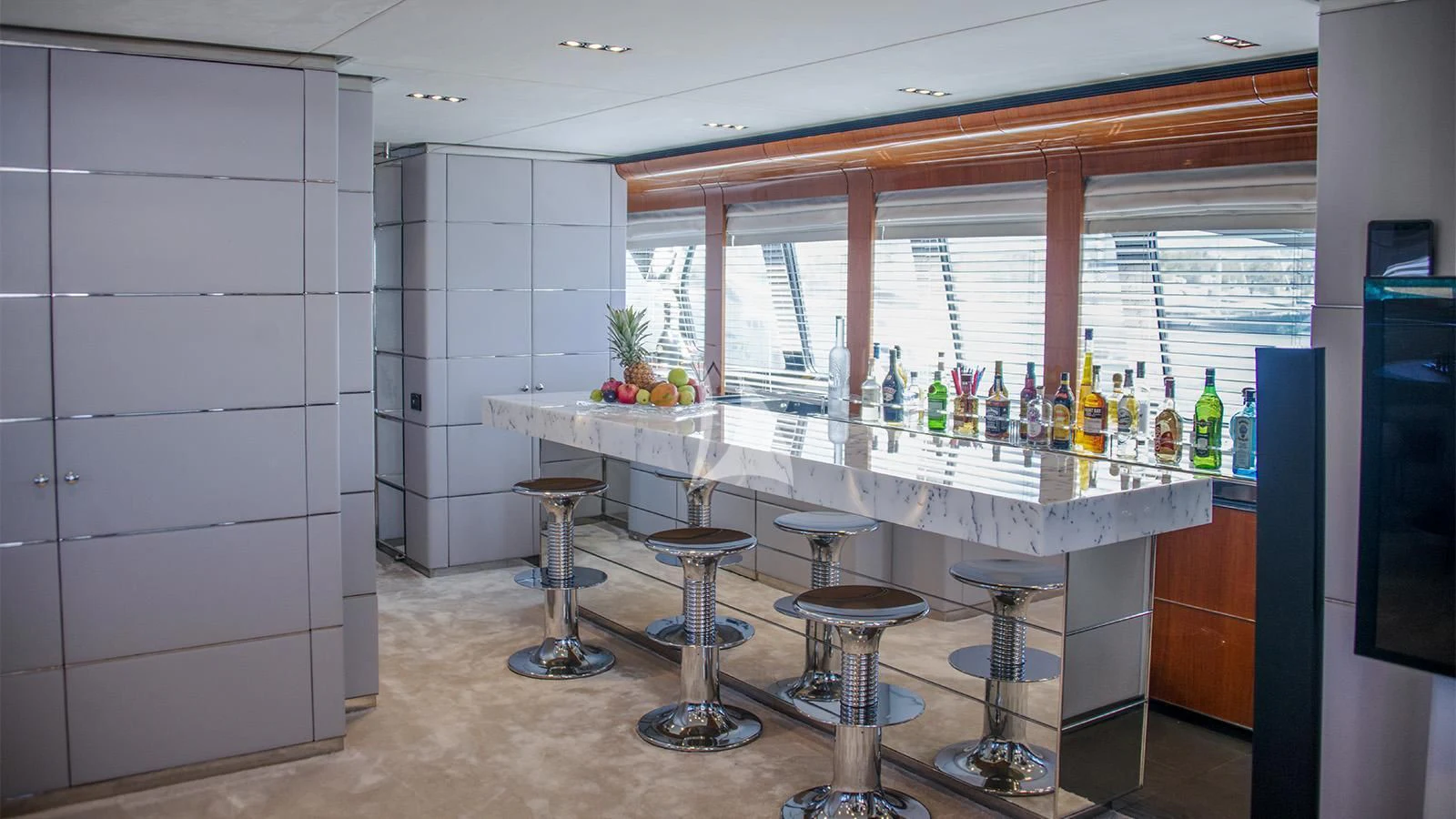 a bar with a bar and stools aboard BLISS Yacht for Sale