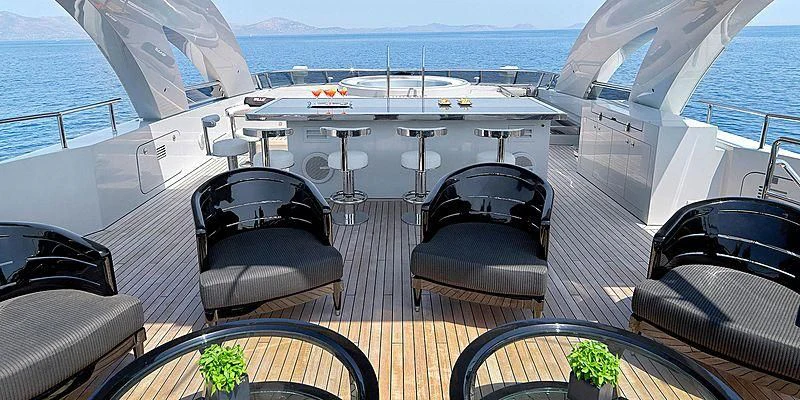 a deck with a large boat and a pool aboard BLISS Yacht for Sale