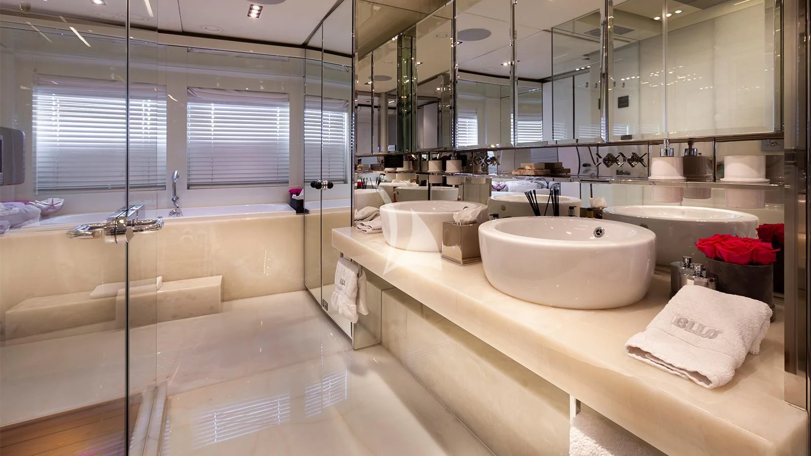 a bathroom with a sink and a large mirror aboard BLISS Yacht for Sale