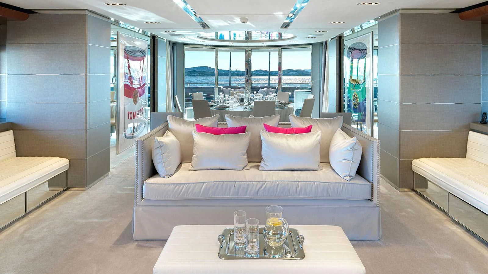 a room with a couch and a table with glasses on it aboard BLISS Yacht for Sale