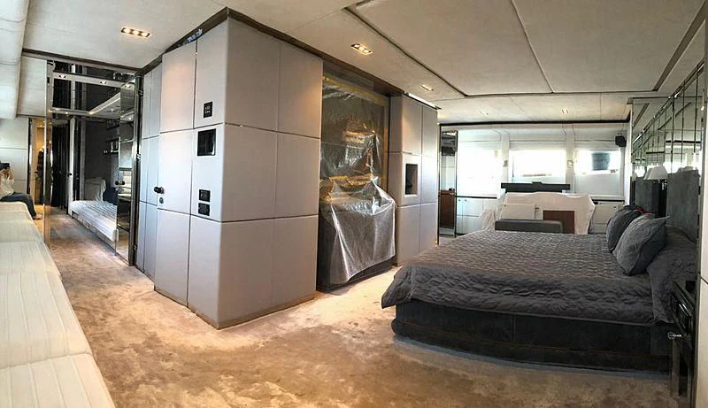 a large room with a bed and a large window aboard BLISS Yacht for Sale