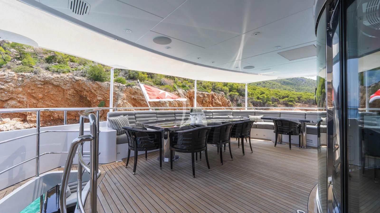 a deck with a table and chairs aboard BLISS Yacht for Sale