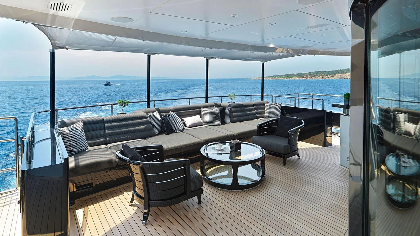 a room with a couch and a table and chairs aboard BLISS Yacht for Sale
