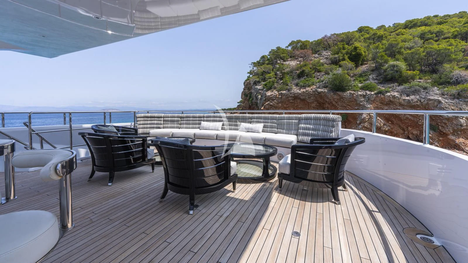 a deck with a table and chairs on it aboard BLISS Yacht for Sale