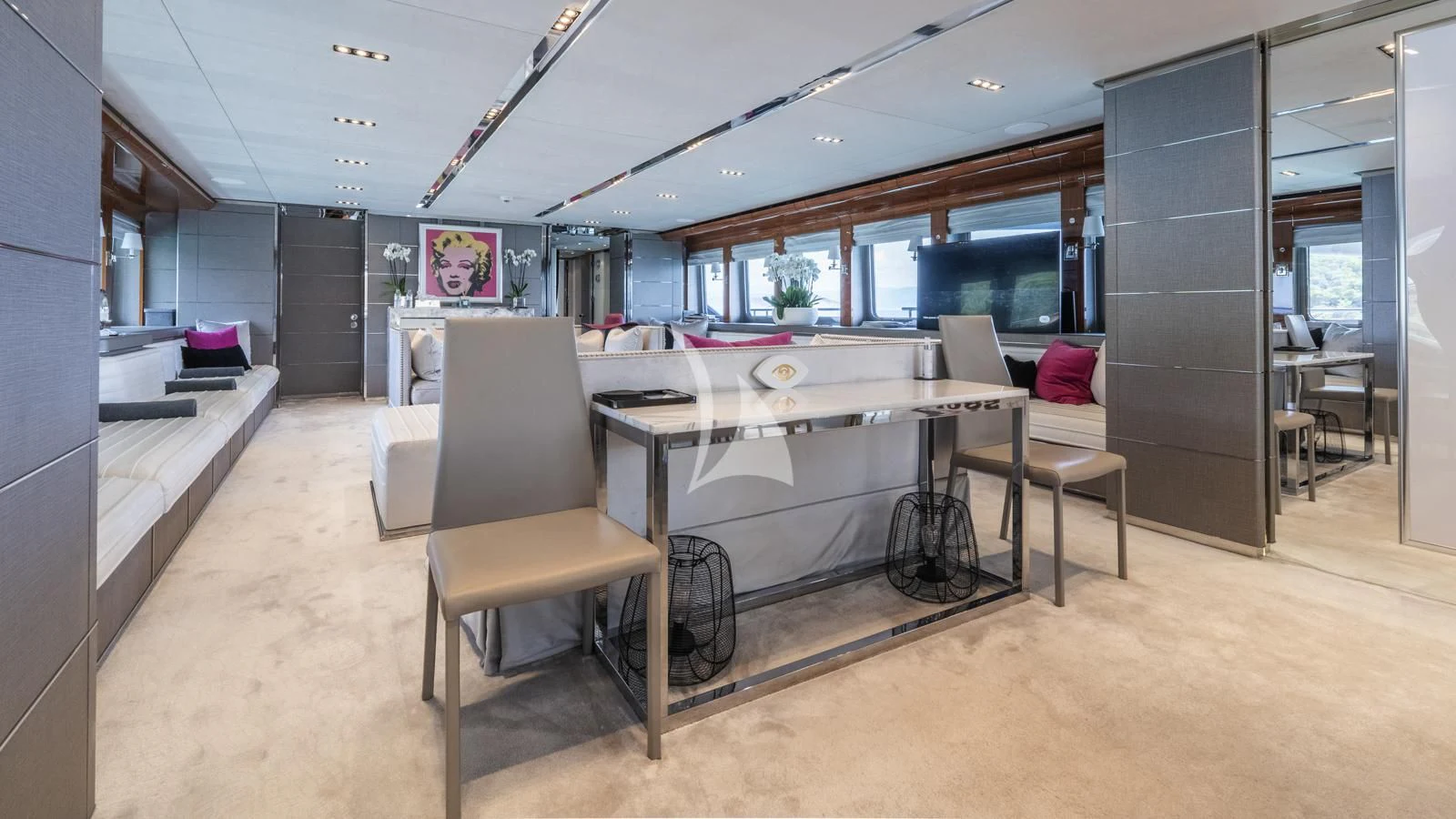 a large room with a table and chairs aboard BLISS Yacht for Sale