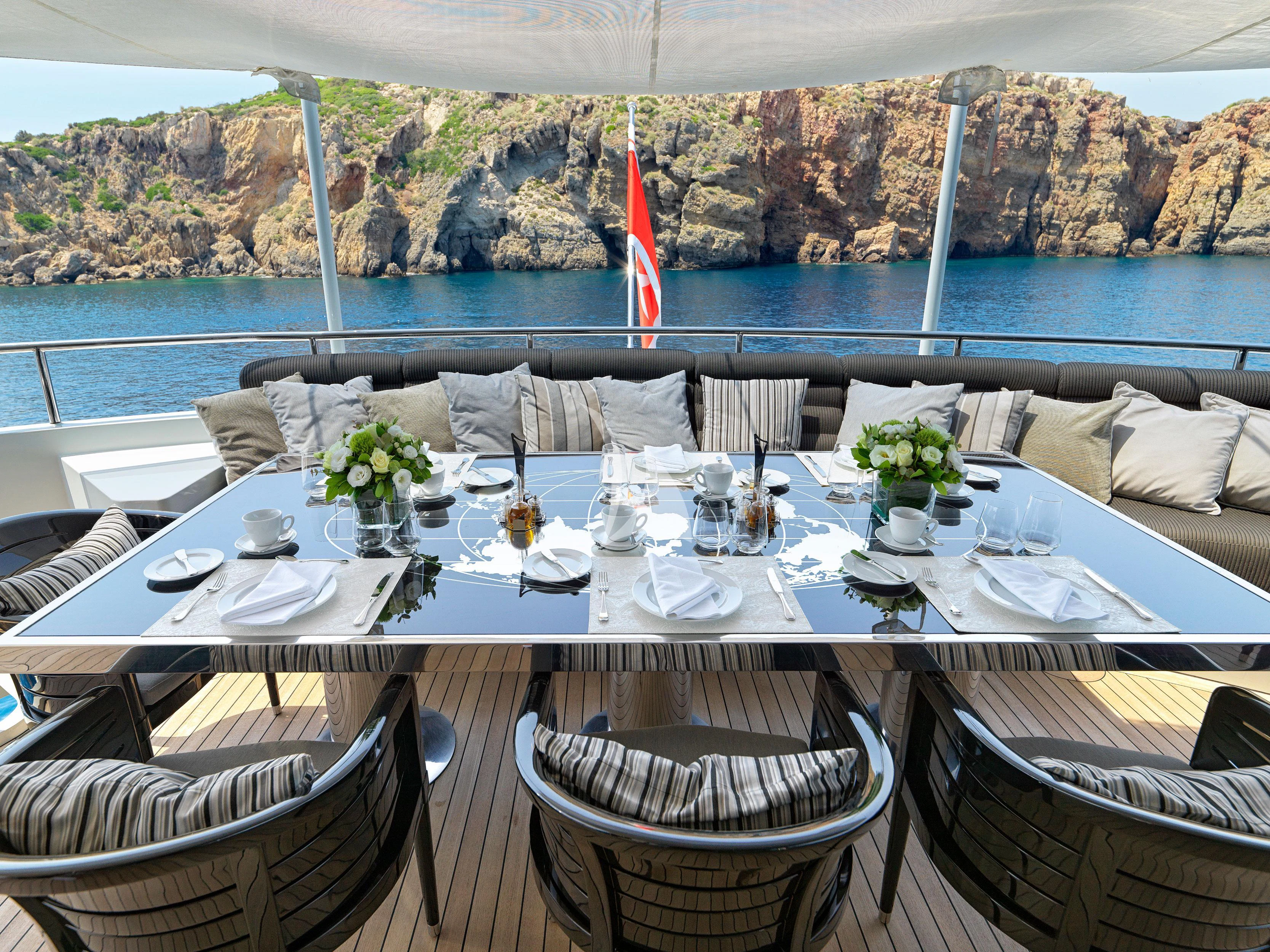 a table set with place settings aboard BLISS Yacht for Sale
