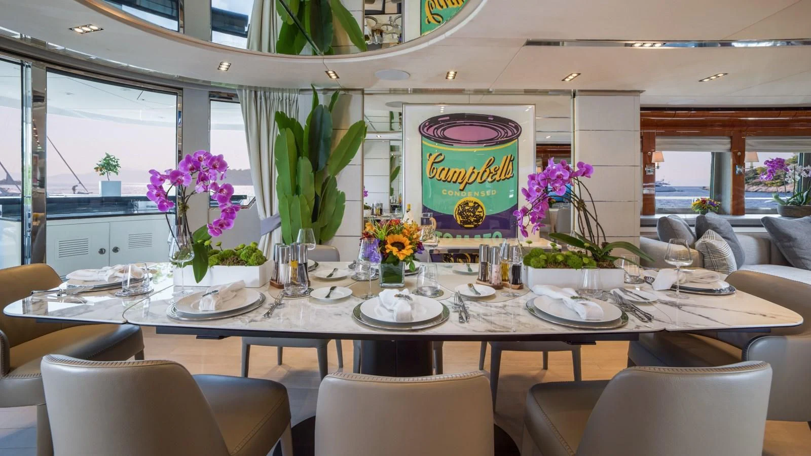 a table with plates and flowers aboard BLISS Yacht for Sale