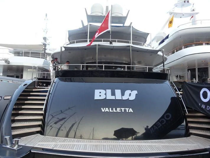 a boat with a flag on the deck aboard BLISS Yacht for Sale
