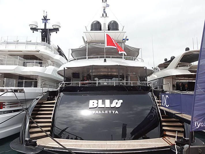 a large ship with a flag on the front aboard BLISS Yacht for Sale