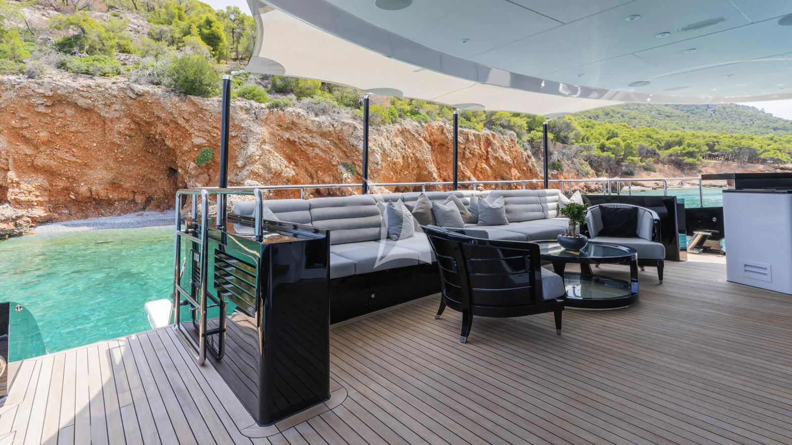 a deck with a table and chairs aboard BLISS Yacht for Sale