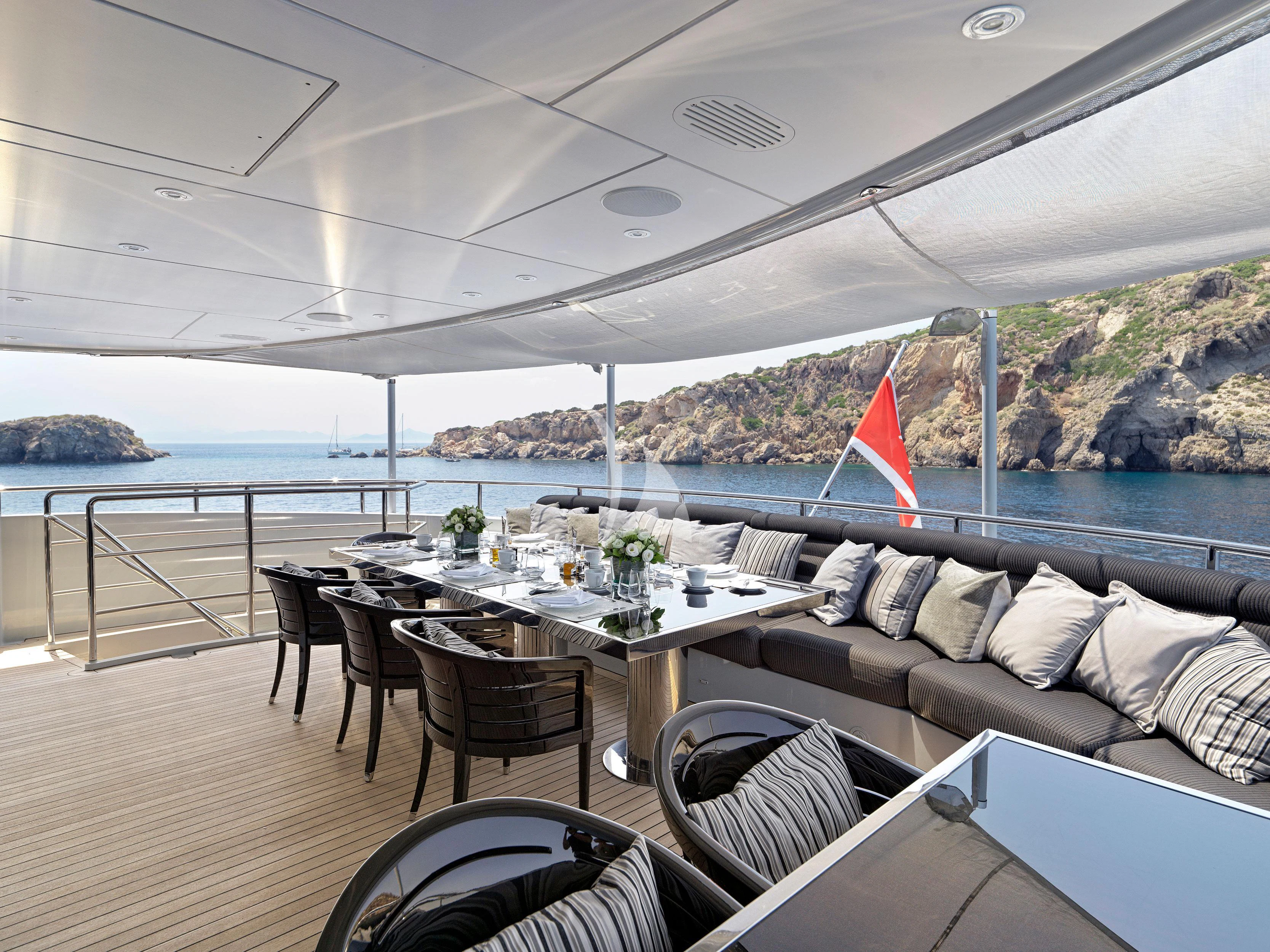 a table and chairs on a deck aboard BLISS Yacht for Sale