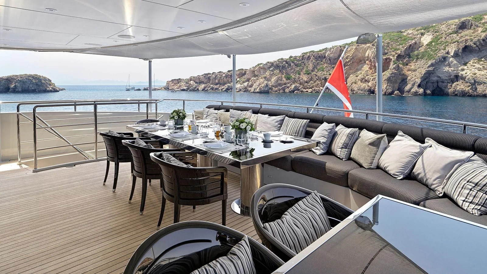 a table and chairs on a deck aboard BLISS Yacht for Sale
