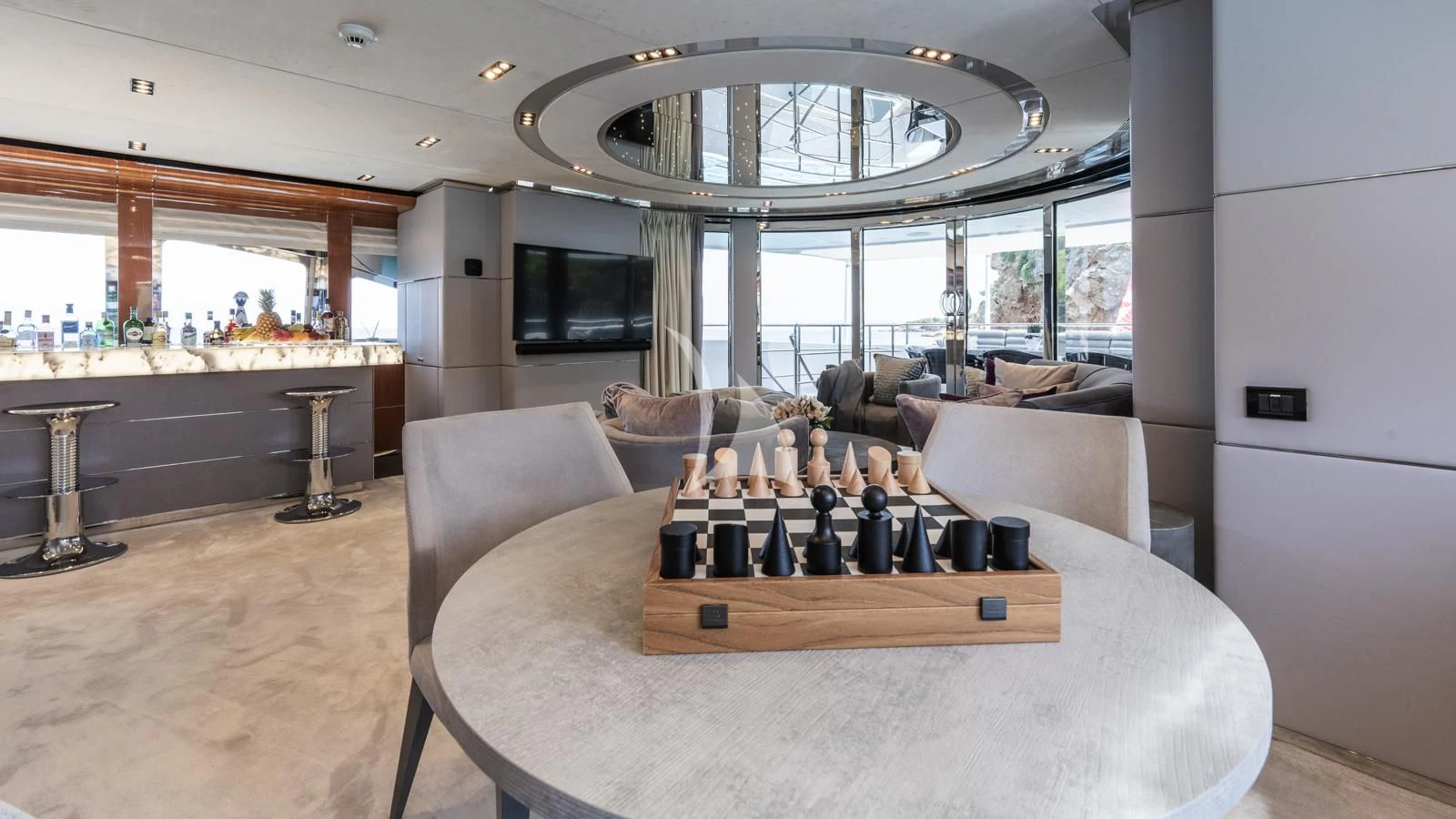 a large living room with a large table and a large window aboard BLISS Yacht for Sale