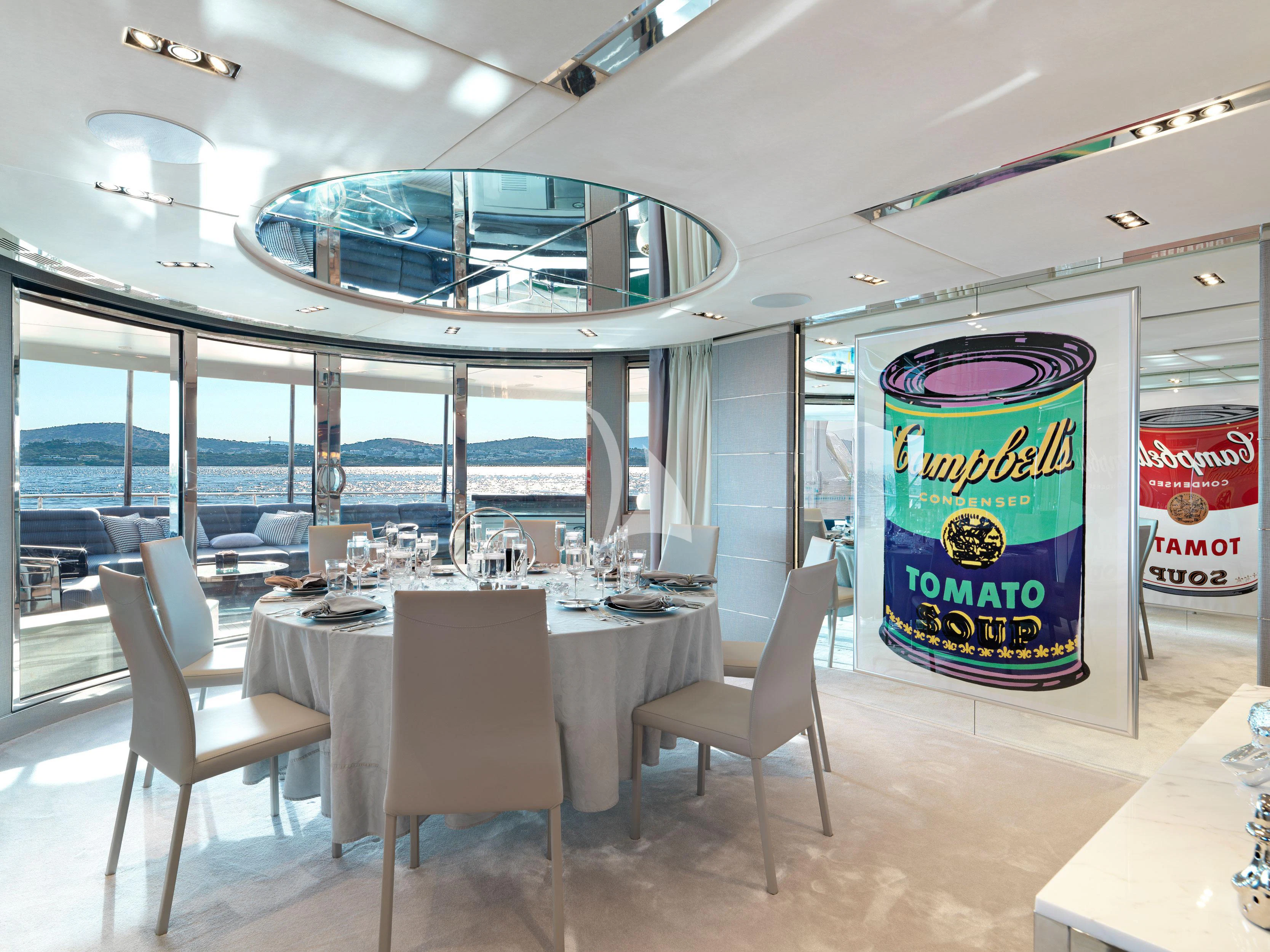 a large room with tables and chairs aboard BLISS Yacht for Sale