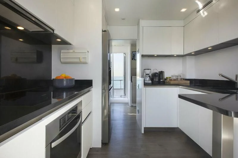 a kitchen with white cabinets aboard SANLORENZO SL82-570 Yacht for Sale