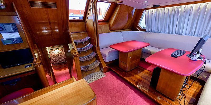 a room with a couch and a table aboard SCORPIUS Yacht for Sale