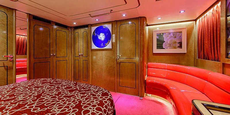 a room with a bed and a tv on the wall aboard SCORPIUS Yacht for Sale