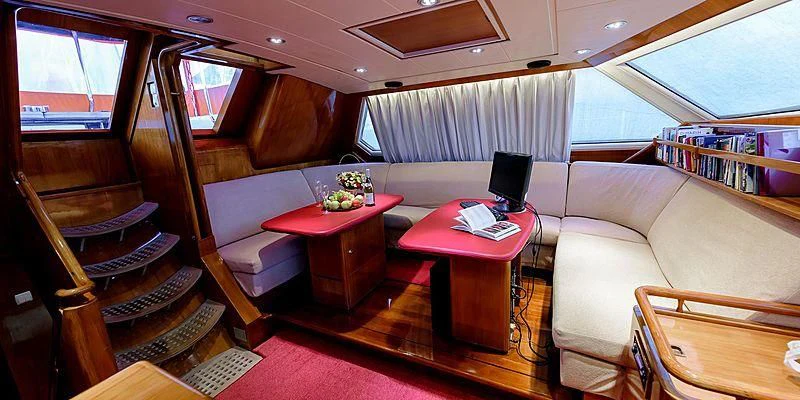 a train with a table and chairs aboard SCORPIUS Yacht for Sale