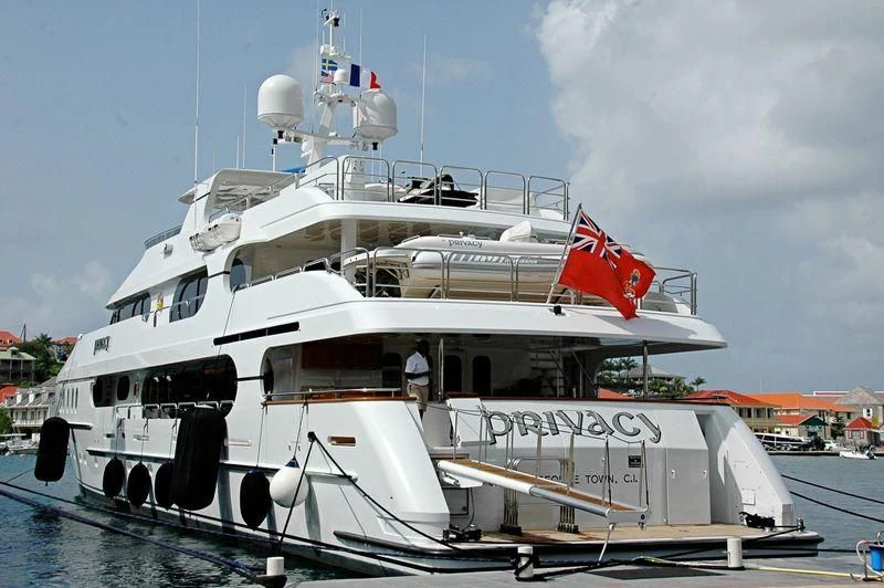 a large white boat with a red and white flag on it aboard PRIVACY Yacht for Sale