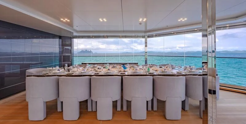 a row of white toilets in a room with a view of the water aboard WANDERLUST Yacht for Charter