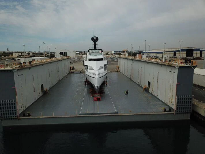 a large white boat docked at a port aboard WANDERLUST Yacht for Charter